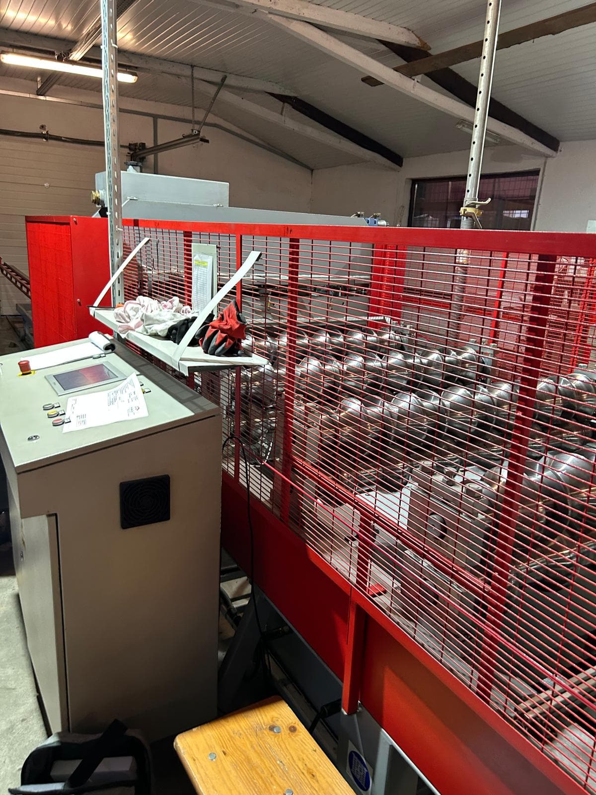 Industrial touchscreen control panel with HMI interface managing automated production machinery