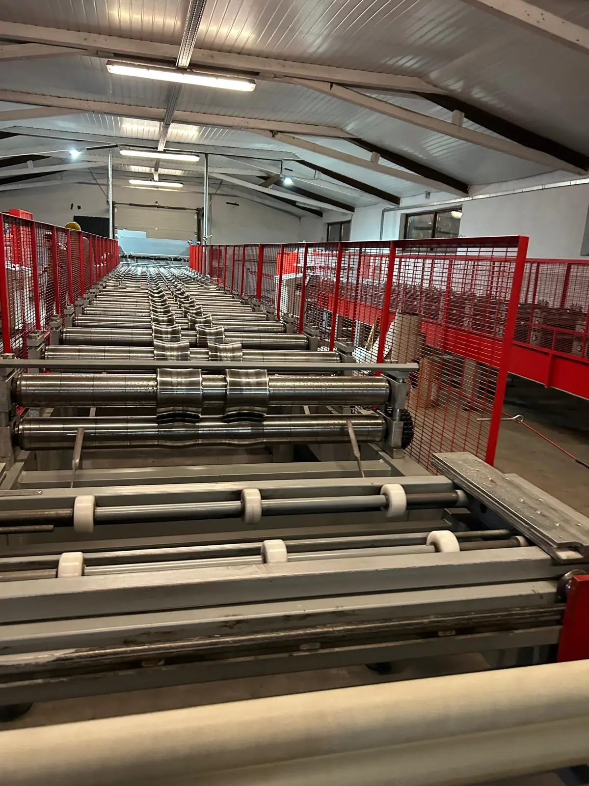Primatronic — Roll Forming Production Line Automation, Cluj-Napoca Primatronic roll forming production line with precision rollers and automated safety cage — industrial automation Cluj-Napoca Romania