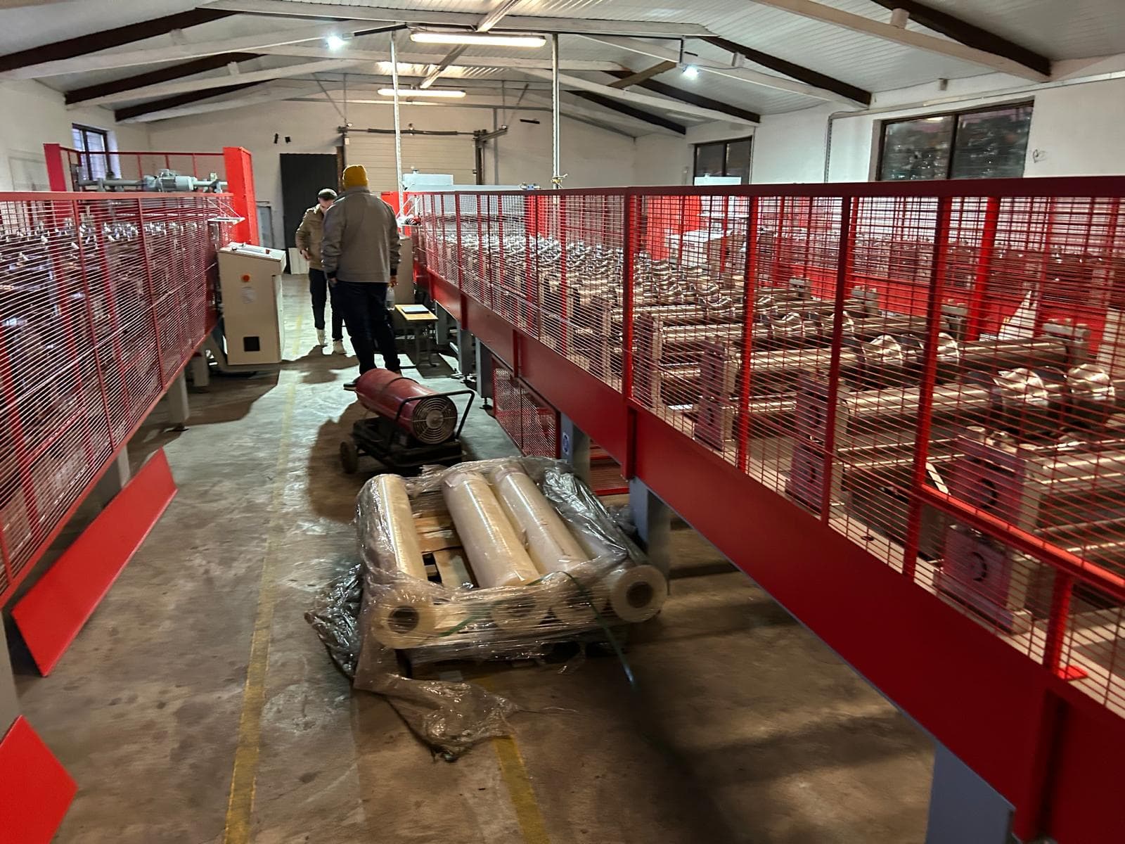 Smart Factory Operations - Production Line Monitoring Factory operators managing automated roll forming production line with real-time monitoring